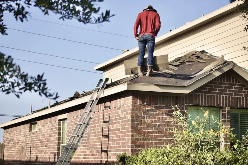 Professional roofer working on a residential roof in Maypearl